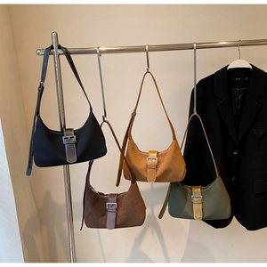 Detail view of retro suede hobo bags in four colors with vintage metal buckle design