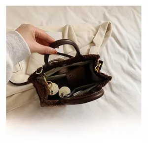 Interior view of brown faux fur tote bag showing spacious capacity and magnetic clasp