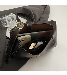 Internal view of dark brown bucket bag showing large capacity for essentials