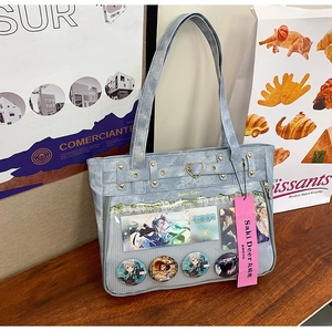 Detail of light blue ita-bag featuring a transparent display window and heart buckles