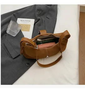 Detailed interior of caramel suede hobo bag with zip pocket and large storage space