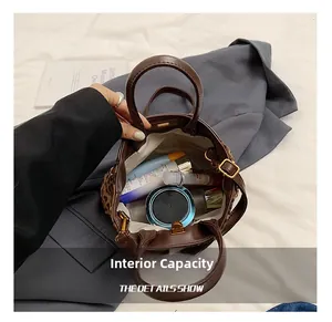 Internal view of leopard print handbag showing storage capacity for cosmetics and skin care