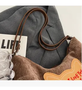 Detail of corduroy tote bag featuring bear embroidery and I LOVE YOU text patch