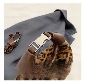 Detail of leopard print suede handbag with premium silver metal clasp and leather handle