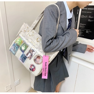 Detail of oxford fabric ita bag featuring transparent window with lace and heart accents