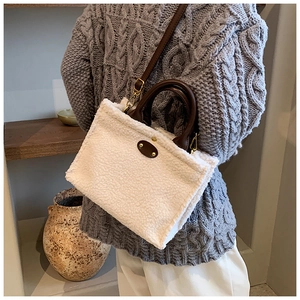 Detailansicht der weißen Plüsch-Tasche mit braunen Ledergriffen und Schulterriemen