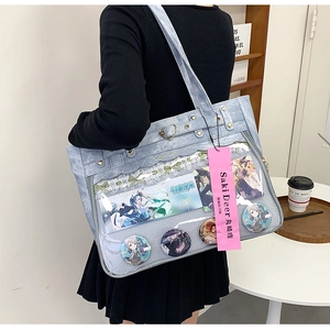 Close-up of light blue Oxford ita bag with clear PVC window for anime badge display