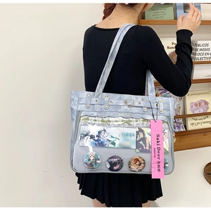 Close-up of light blue Ita bag with transparent PVC layer and lace ribbon detailing