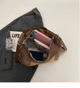 Spacious interior of dark brown tote bag holding a pink tablet and smartphone