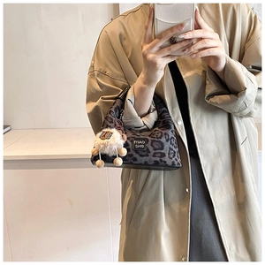 Leopard print hobo bag with plush sheep charm shown in a daily casual commute outfit