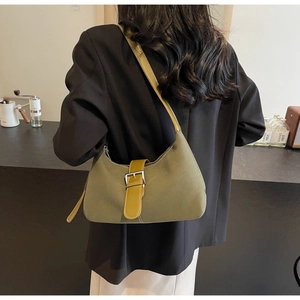 Dark green hobo shoulder bag shown on model in a sophisticated lifestyle setting
