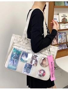 Chic beige canvas ita-bag tote featuring a large transparent window and heart studs