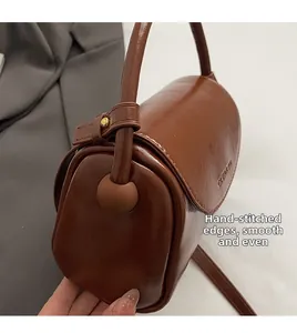 Detail of smooth polished brown leather boston bag with premium manual stitching