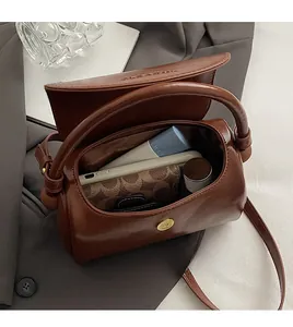 Top view of brown leather bag interior showing spacious storage for essentials