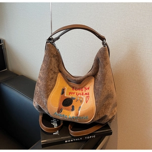 Detail of vintage cat embroidery on brown textured corduroy hobo shoulder bag