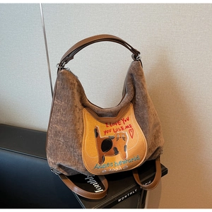 Detailed texture of brown corduroy bag featuring a cute cat patch and PU leather strap