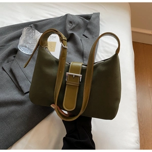 Detailed close-up of olive green tote bag with matte texture and silver metal buckle