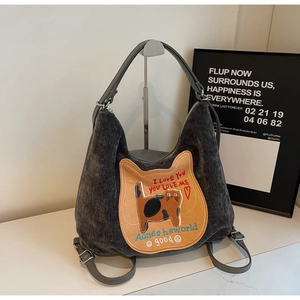 Close-up of dark grey corduroy tote bag featuring an orange cat embroidery patch