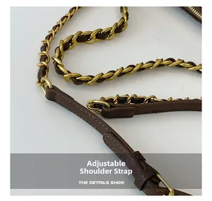 Detail of adjustable dark brown leather and vintage gold chain strap for shoulder bag