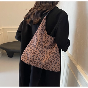 Modern leopard print tote bag styled on model in a minimalist home setting