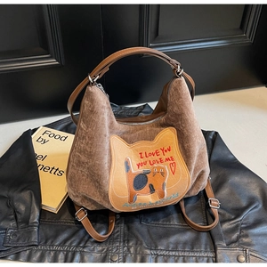 Detail of warm brown corduroy tote bag with cat embroidery on a vintage background