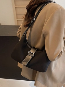 Minimalist black hobo shoulder bag with silver buckle and white contrast stitching detail
