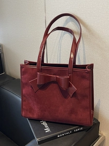 Vintage burgundy suede tote bag with large bow and glossy leather trim detail