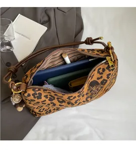 Leopard print tote bag interior showing capacity for tablet, wallet, and folding umbrella