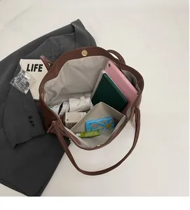 Internal view of brown large capacity tote bag with magnetic clasp and spacious storage