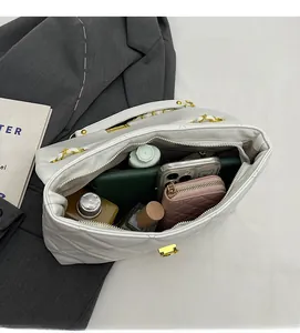 Spacious interior of white quilted chain bag showing room for phone and wallet