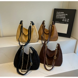 Matte retro hobo bags in four colors with gold chain straps on white display steps