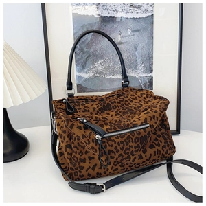 Détail du sac cabas léopard avec poignées en cuir noir et poche zippée argentée