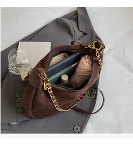 Interior view showing the large capacity of the brown suede bag with daily essentials