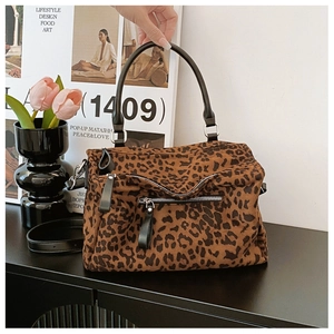 Détail du sac cabas léopard avec poignées en cuir noir et fermeture à glissière