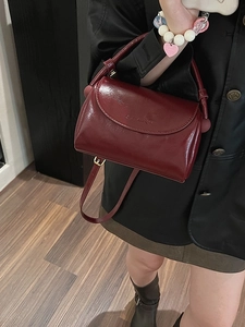 Retro burgundy patent leather handbag with gold hardware and adjustable strap