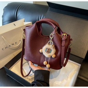 Retro burgundy faux leather tote bag with plush charm and adjustable shoulder strap