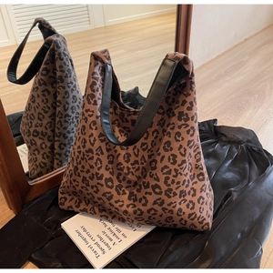 Detailed mirror reflection view of leopard print tote bag with faux leather straps