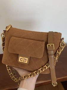 Brown quilted suede shoulder bag with gold chain strap and vintage crossbody design