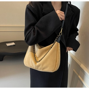 Detail of khaki frosted hobo bag featuring mixed gold and black metal chain decoration
