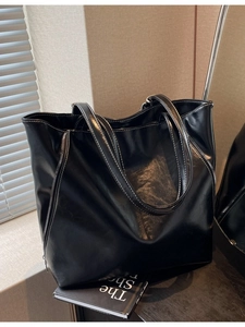Large black vintage tote bag with contrast stitching and side zipper details