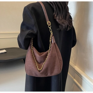 Brown matte faux suede moon bag with vintage gold chain strap shown on person
