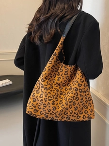 Large leopard print tote bag with black strap shown on model for autumn winter style