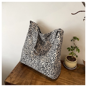 Close-up of leopard print canvas tote bag showing thick durable fabric texture and large capacity