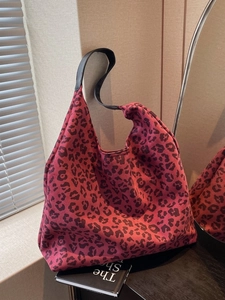 Fashionable leopard print hobo tote bag in vibrant rose red with black leather handle