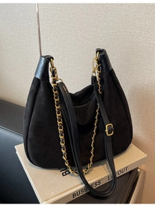 Matte black vintage hobo bag with gold chain strap on books for stylish daily commute