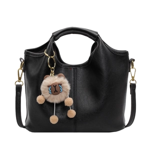 Retro black leather tote bag with large capacity and cute plush puppy charm accessory