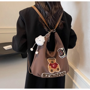 Brown tote bag with teddy bear embroidery and cloud charm in a trendy college style