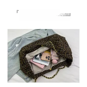 Detail view of large leopard print tote bag interior showing spacious storage capacity