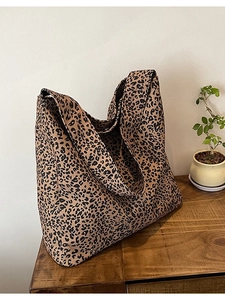 Large leopard print canvas tote bag for women shown in a natural lifestyle setting