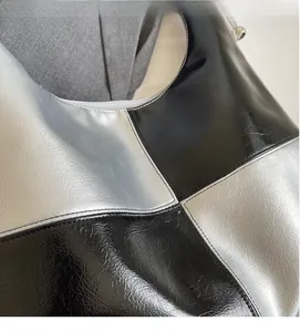 Detail of the soft black and silver checkered fabric texture with reflective metallic finish